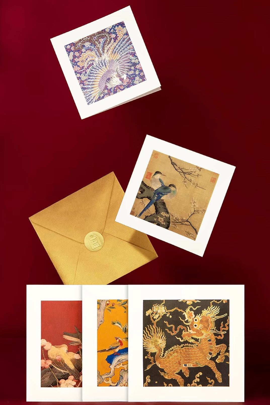 A set of art prints and a gold envelope greeting cards. The prints feature traditional East Asian-style illustrations, including a phoenix, a bird on a branch, and a golden dragon, each with a white border.