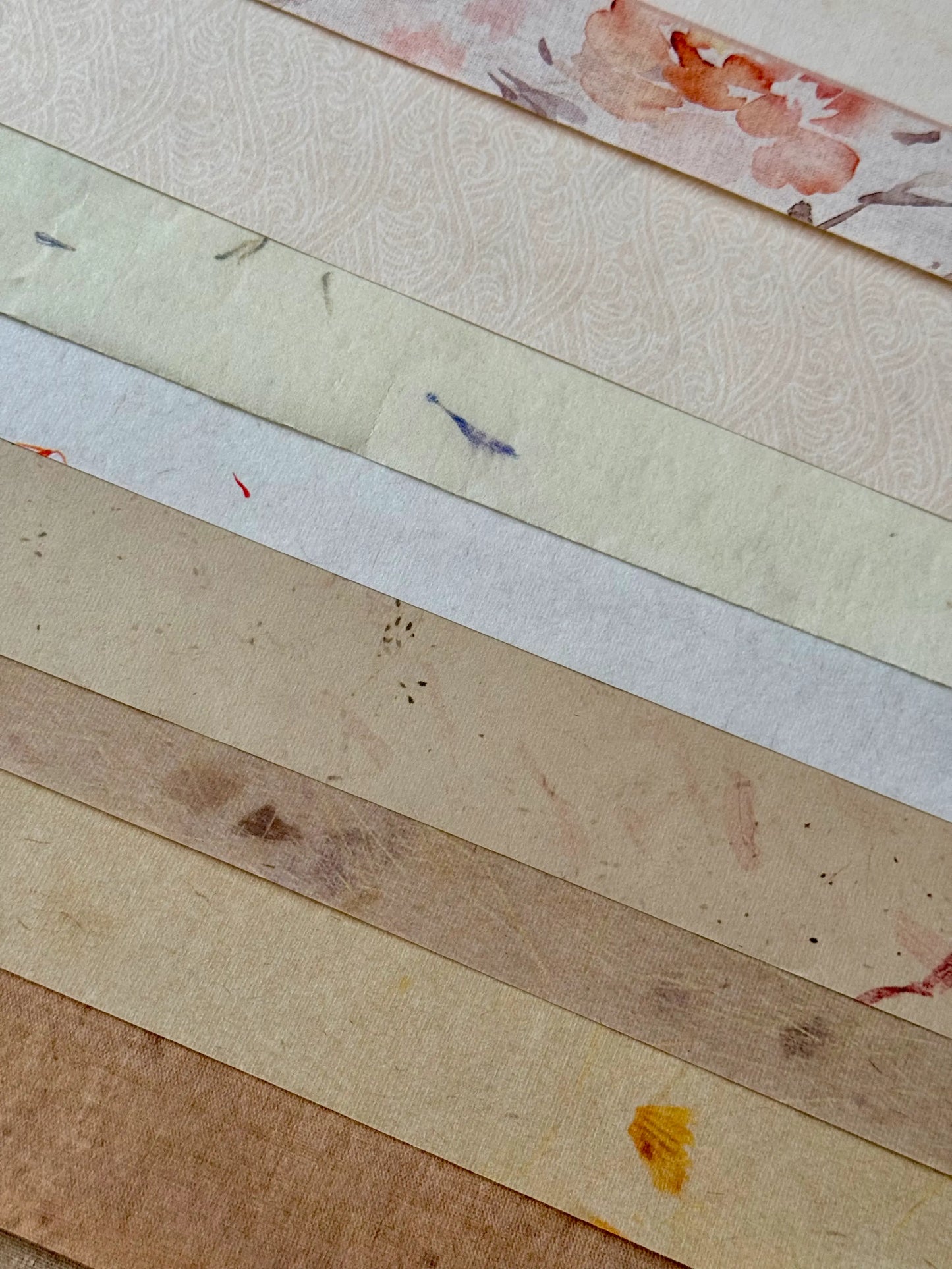 Collection of different types of paper with various textures and colors.