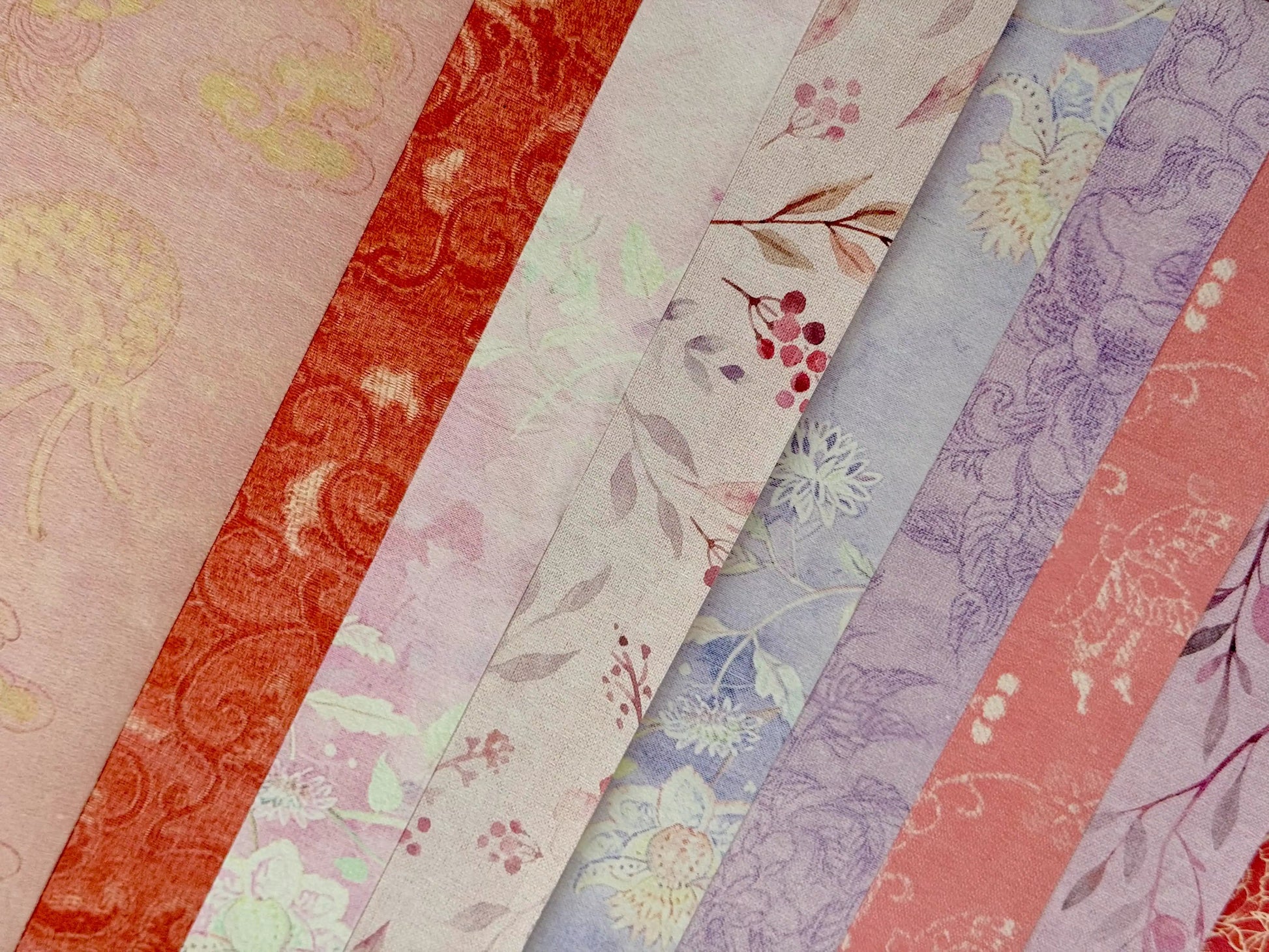 Stack of floral-patterned paper sheets in various colors.