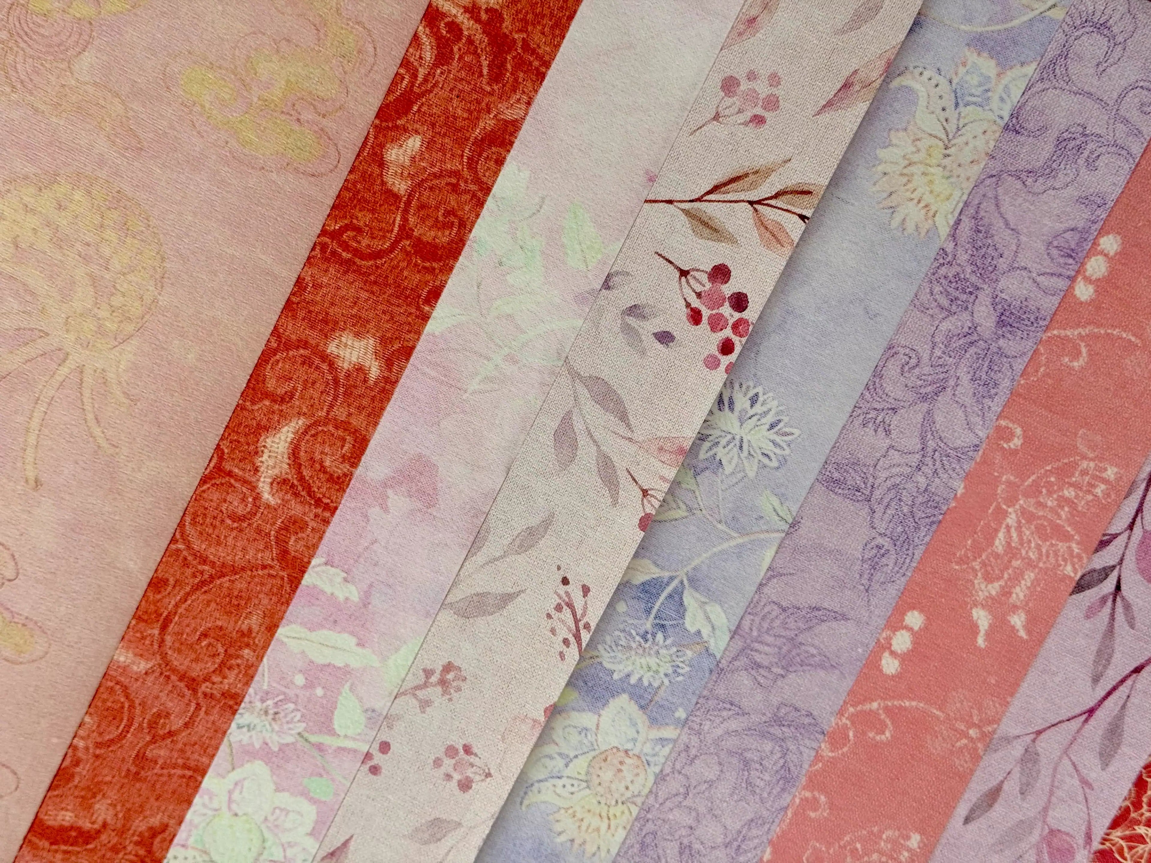 Stack of floral-patterned paper sheets in various colors.